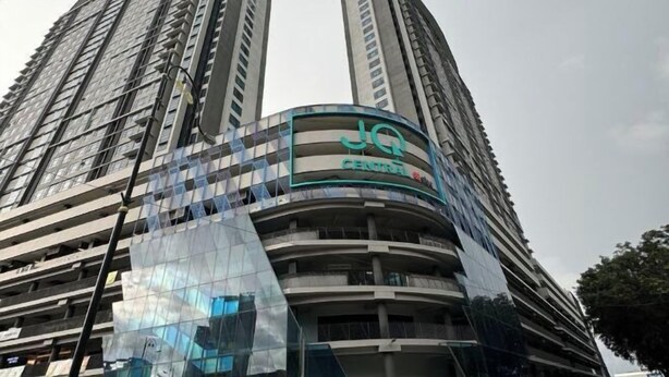 A high-rise building with a curved facade and a sign that reads "JG CENTRAL". - JQ#11 City View Slide LoftBed 2R1B 5Pax Near Suria Mall, Gaya St, Sicc (Kota Kinabalu)