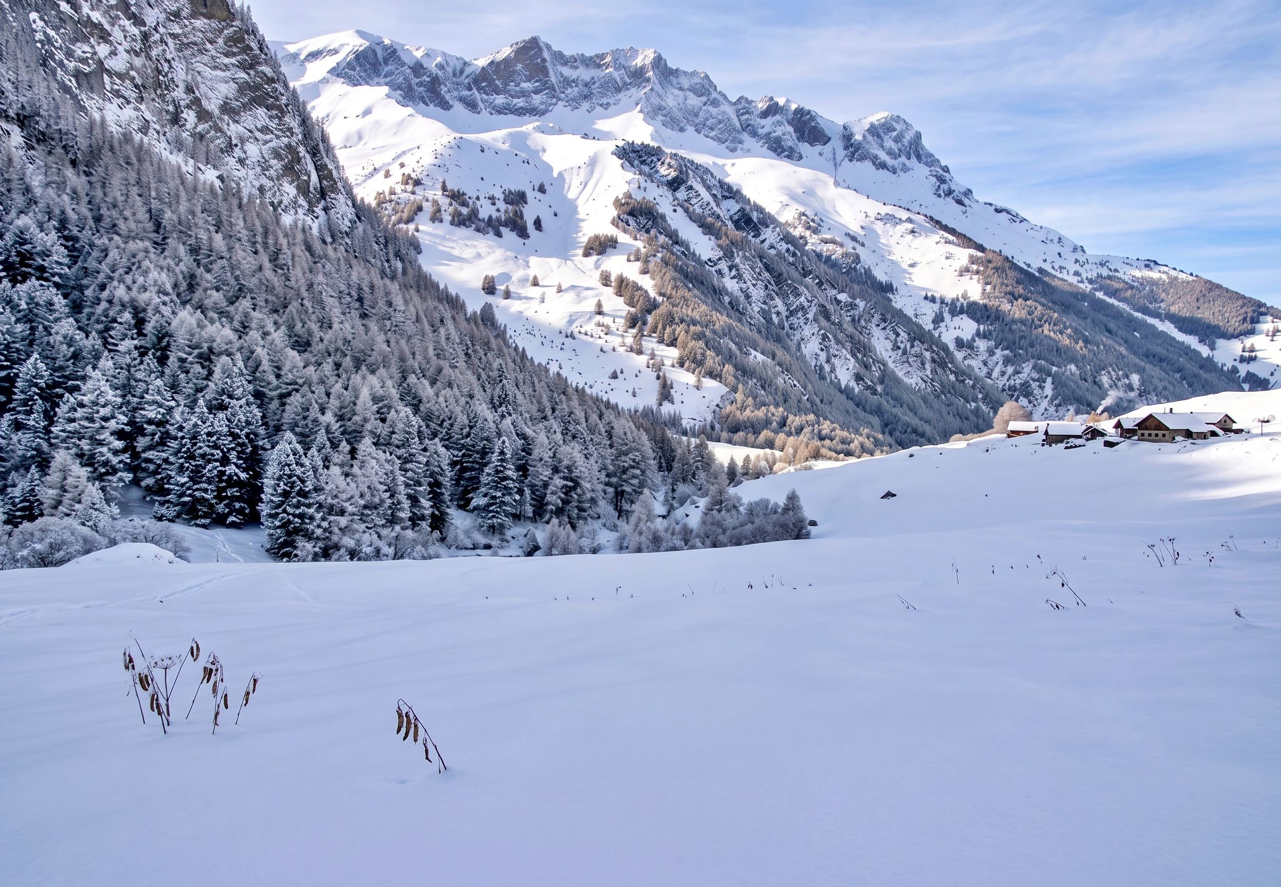 A snow-covered mountain landscape with a ski resort.