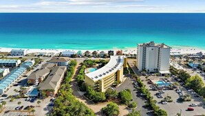 A coastal hotel with a pool, beach view, and multiple buildings. - Beach Resort 514 (Miramar Beach)