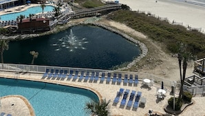 A resort with a pool, beach, and ocean view.