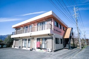 A two-story building with a balcony on the upper floor, a red awning, and a sign that reads 'Hotel'. - Suzuka Smile Room (Suzuka)
