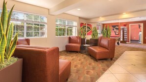 A lobby with seating, large windows, and indoor plants. - WorldMark Spencer Street - 1 Bedroom (Las Vegas)