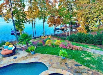 Backyard bliss. Complete with Patio, Pool, Hot Tub, Waterfall and dock.