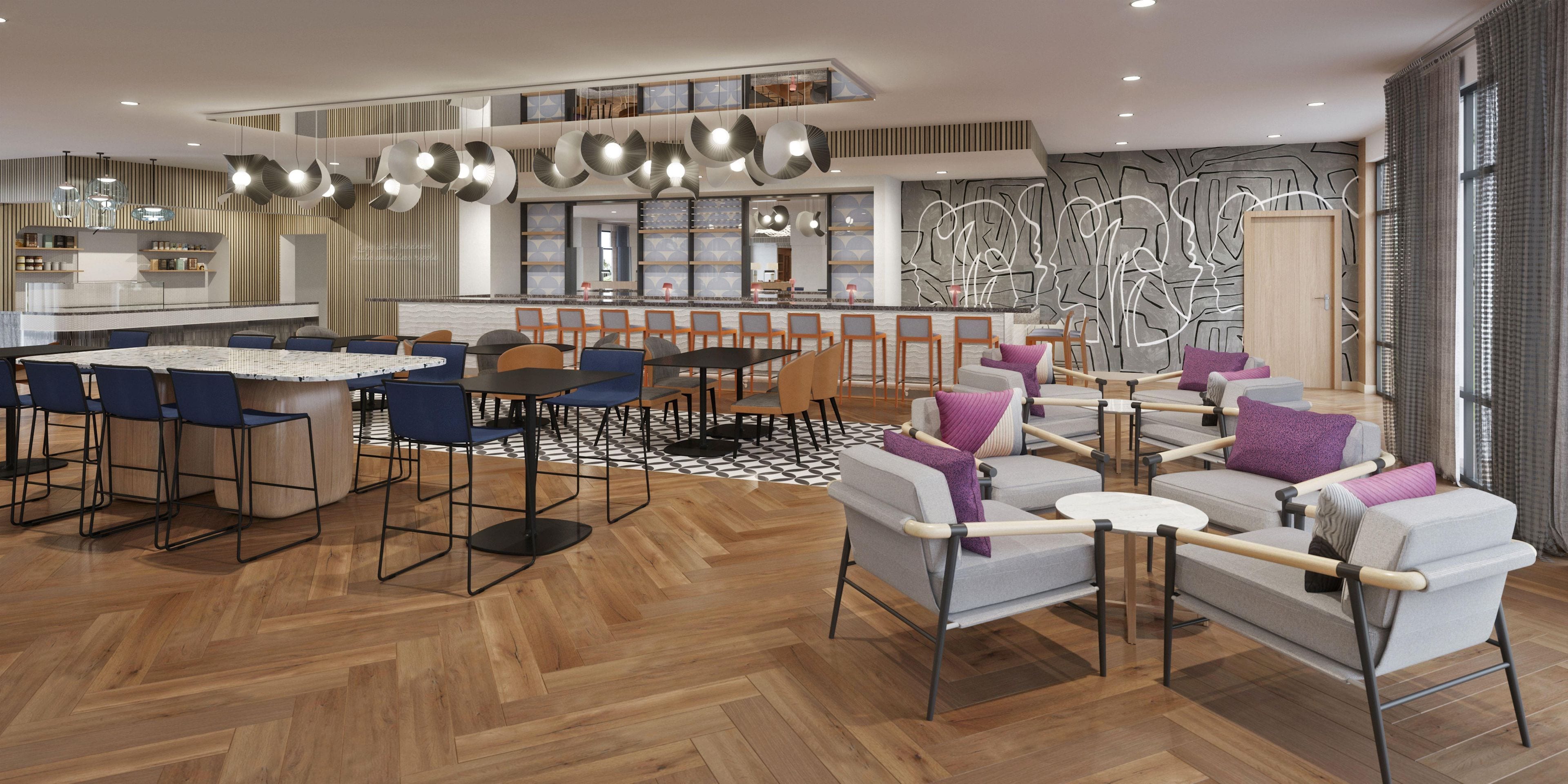 A modern interior with a dining area, seating, and a kitchen.
