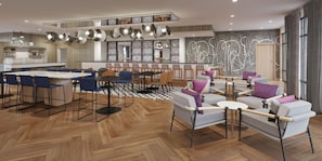 Un intérieur moderne comprenant un coin repas, un espace salon et une cuisine.