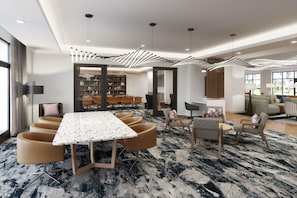 Une chambre d’hôtel moderne dotée d’un coin repas avec une table en marbre et des chaises contemporaines.