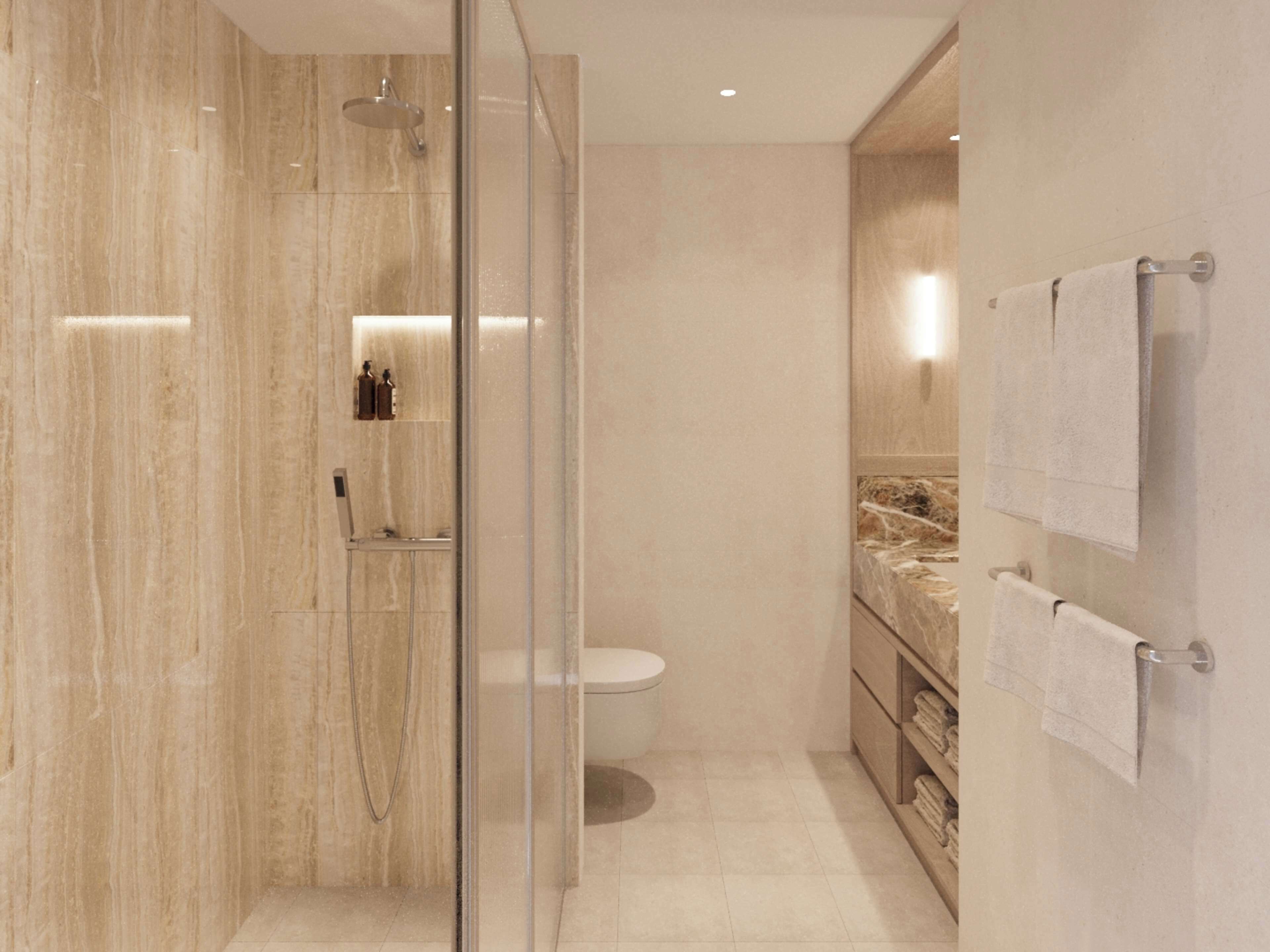 A modern bathroom with a glass-enclosed shower, a toilet, and a marble vanity with towels.