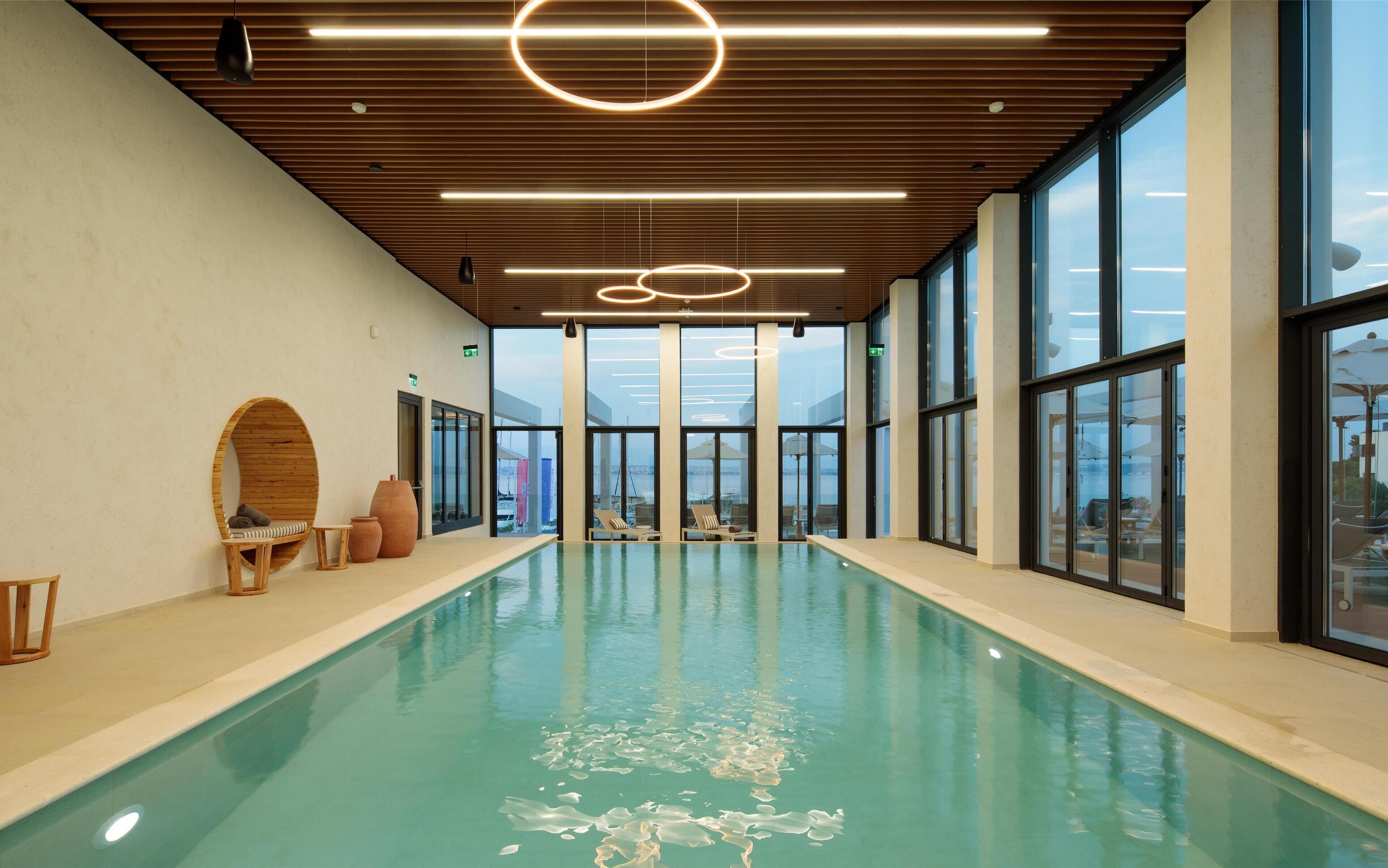Indoor pool, outdoor pool, pool umbrellas, pool loungers