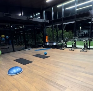 Work out in style with a fully equipped gym featuring stationary bikes, rowing machines, and exercise balls.
