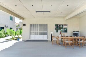 A covered outdoor area with a seating arrangement, a door, and a window. - Banyan Tree Villa Hotel (Semporna)