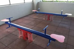 Two exercise benches with red and blue seats and supports, arranged in a tiled room. - Atlantis Residence by Jeffery Lam Home Management (Melaka)