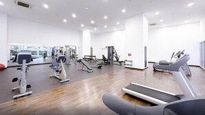 A spacious gym with various exercise equipment, including treadmills and weight machines, and large windows providing natural light. - Sliverscape Premier Suite @ Melaka Raya [Bathtub Sleep 2-4] (Melaka)