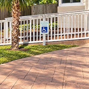 A reserved parking sign with a wheelchair symbol, indicating parking reserved for individuals with disabilities.