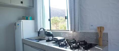 Fridge, stovetop, cookware/dishes/utensils, dining tables