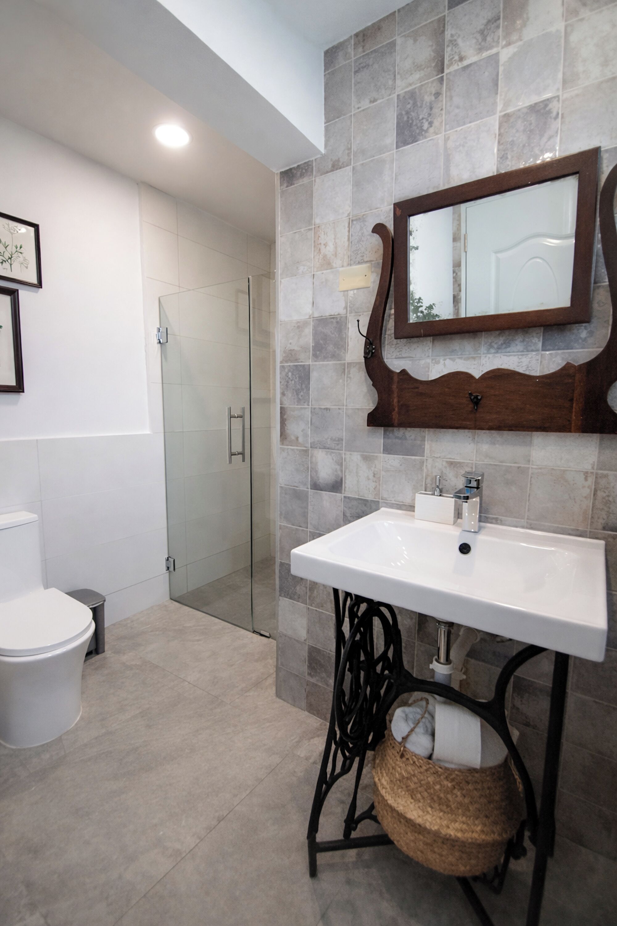 A bathroom with a white sink, a mirror, and a shower.