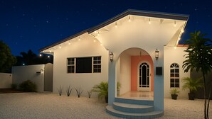 A modern house with a covered porch, a large window, and a door with an arch. - NEW 2 Bed2 Bath Tropical Villa.Ultimate Escape! Private Pool.Covered Patio & BBQ (Savaneta)