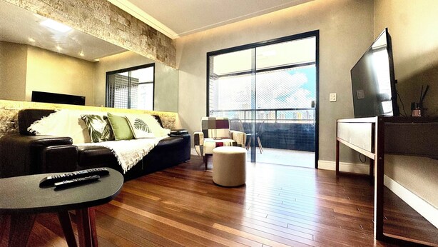 A modern living room with a sofa, a coffee table, and a TV. - COP 30 TWO SUITES (Umarizal Belém)