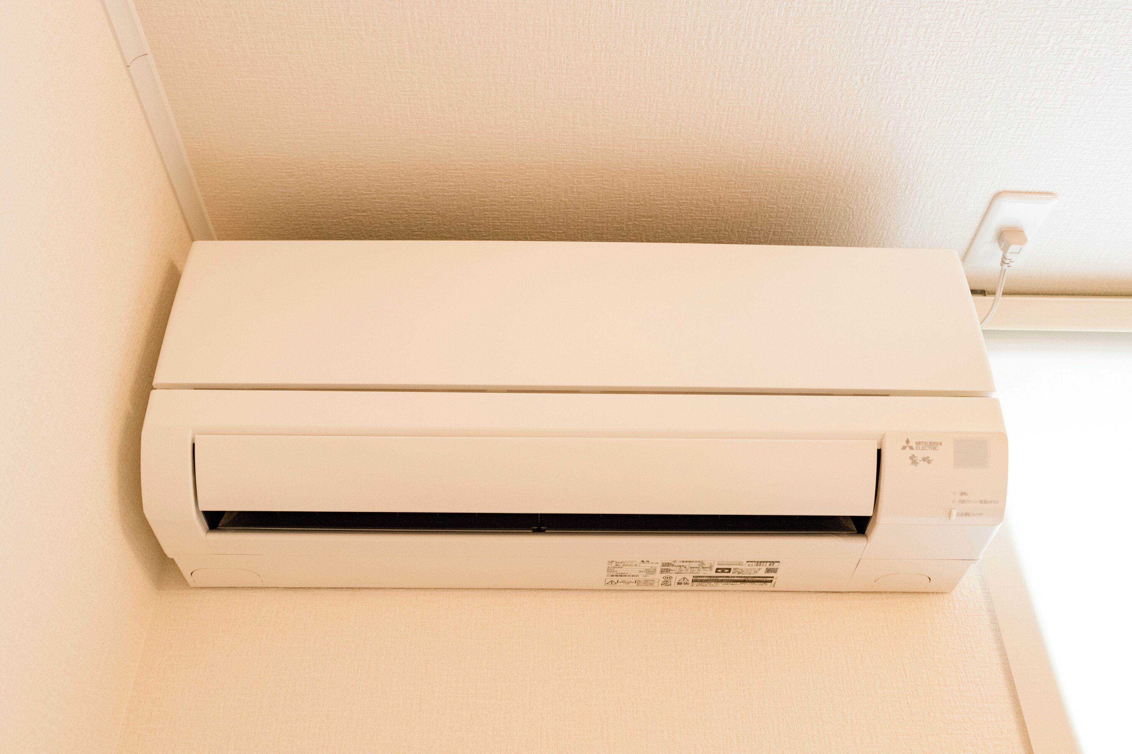 A white air conditioning unit mounted on a wall.