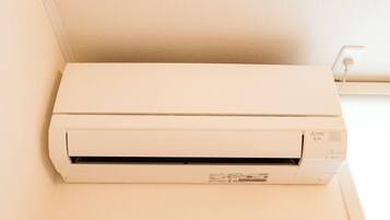 A white air conditioning unit mounted on a wall.