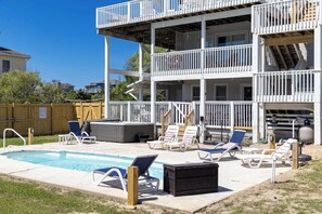 A two-story house with a pool, outdoor seating, and a wooden deck. - Sea Forevermore: Oceanside, Private Pool, 2 Hot Tubs, Elevator (Corolla)