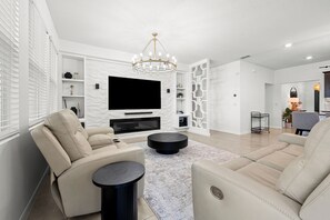 Premium House | Living area | Flat-screen TV, books
