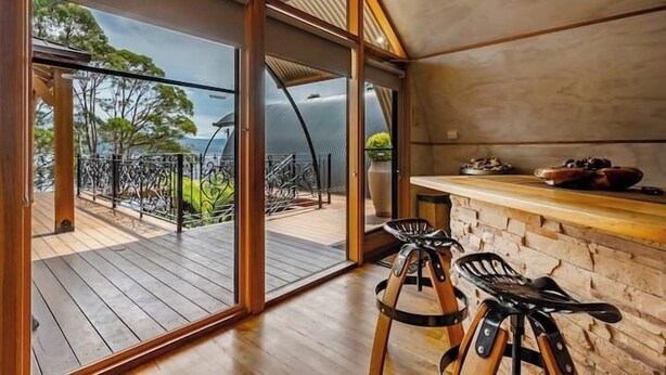 A modern kitchen with a wooden countertop and a view of the outdoors. - Sanctuary Bruny Island - 2 Domes (Adventure Bay)