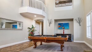 A spacious living area with a pool table, a balcony, and a large painting on the wall. - Wine Country Resort  -  Close to Wineries (Winchester)