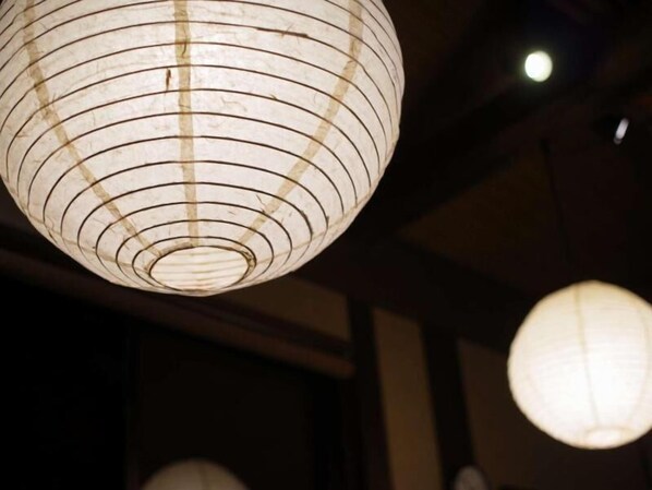 A traditional Japanese paper lantern hanging from the ceiling. - yamakawaonsen kosugian (Oguni)