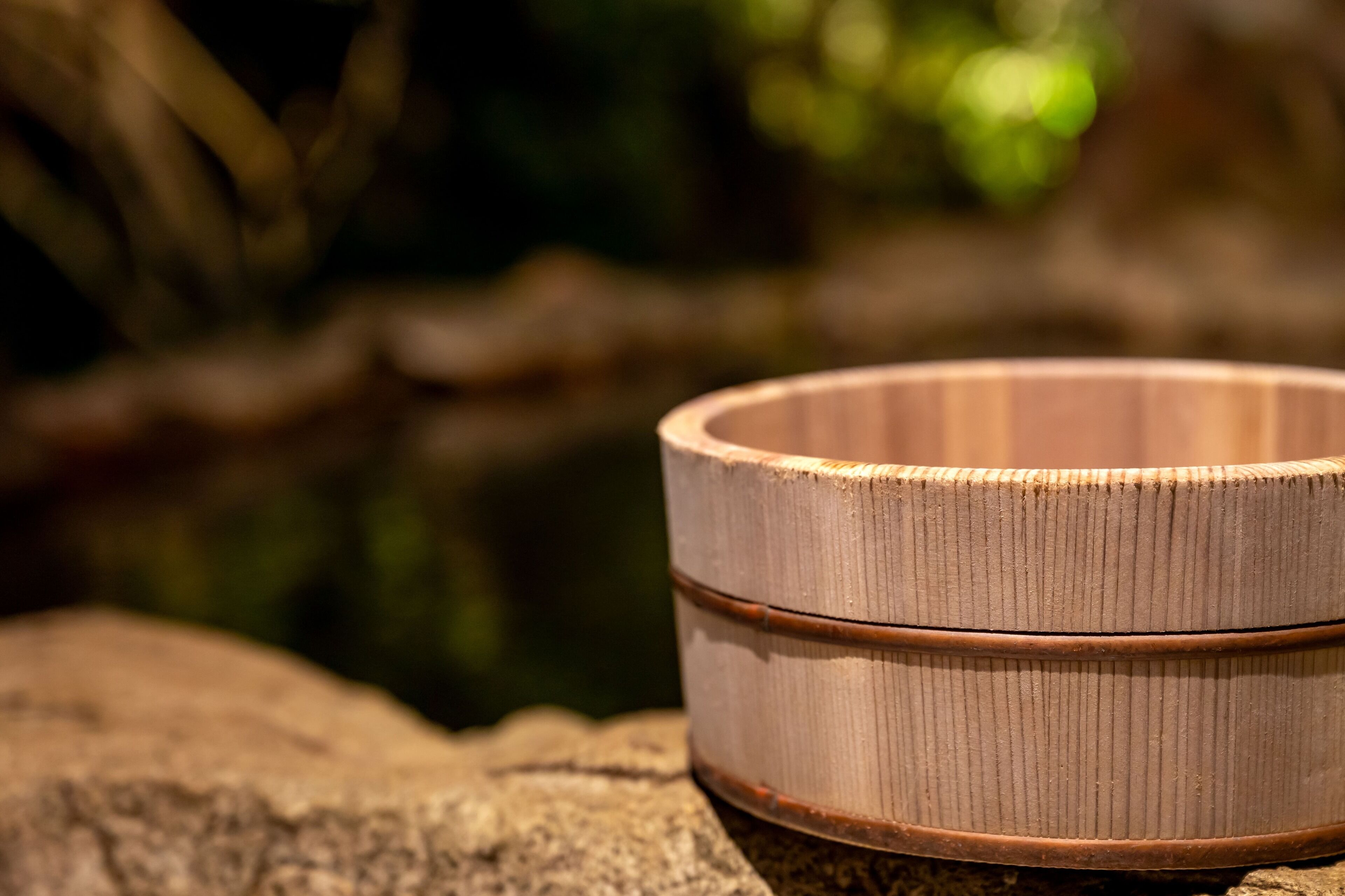 A wooden bowl on a rock.