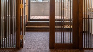 Una tradizionale stanza giapponese con pavimento in tatami, una porta scorrevole shoji e vista sulla città.