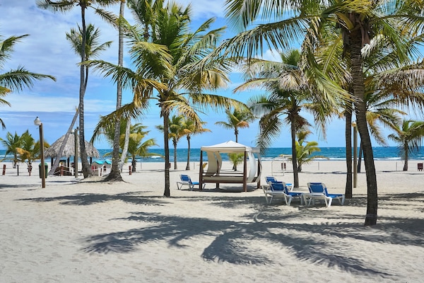Private beach, white sand, sun loungers, beach umbrellas
