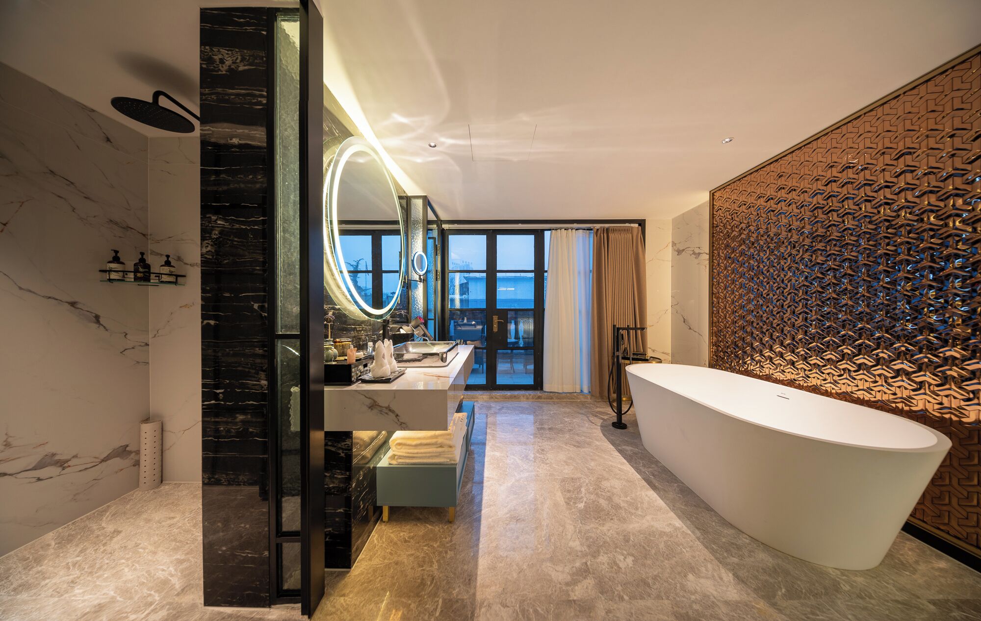 A modern bathroom with a freestanding bathtub, a vanity with a mirror, and a view to the outside.
