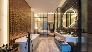 A modern bathroom with a freestanding bathtub, a vanity with a mirror, and a shower area. - SECLUSION TANG (Luoyang)