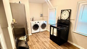 A laundry room with a washing machine, dryer, and stacked washer-dryer unit. - Luxe 2-bedroom apartment near university of Rochester and hospitals.pets allowed (Rochester)