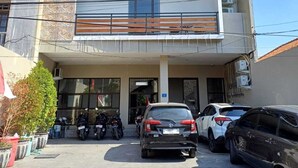 A multi-story building with a flat roof and a balcony on the second floor. - Phoenix Living (Surabaya)