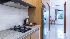 A modern kitchen with a gas stove, a built-in oven, and a stainless steel refrigerator.