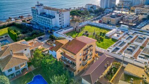 A coastal hotel with multiple buildings, a swimming pool, and a view of the sea. - ROSA DELS VENTS: Very central apartment in l'Escala (L'Escala)