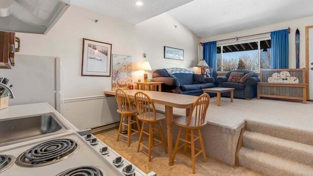 A compact living space with a kitchenette, dining area, and seating area.