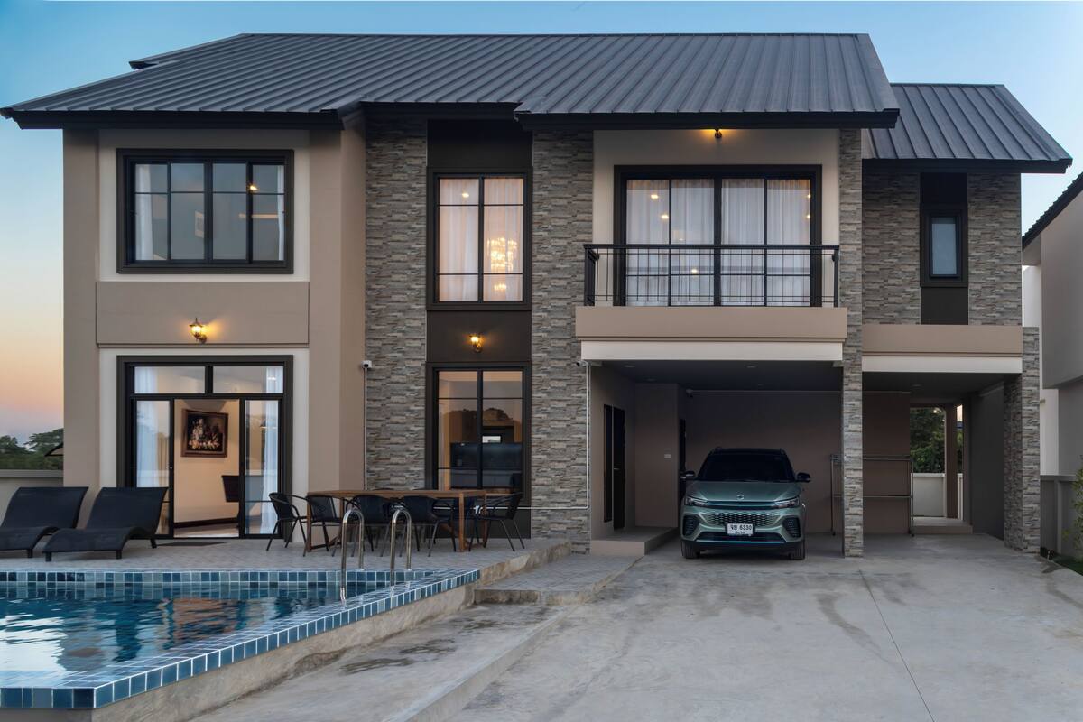 A two-story house with a swimming pool, a covered garage, and a balcony.