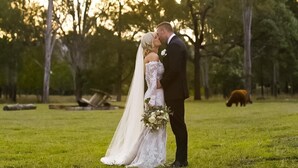 A couple embracing in a grassy outdoor area with trees in the background. - 3 Bdrm Farm Stay with Goats, Hairy Coos and chickens. Farm Life. You'll Love it! (Postmans Ridge)