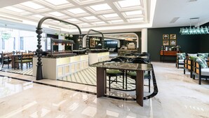 A spacious lobby with a central bar area, seating arrangements, and a high ceiling with skylights. - Vishan Garden Boutique Hotel (Xiamen)
