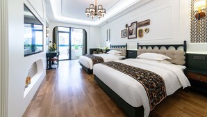 A modern hotel room with two beds, a chandelier, and a view of the outdoors. - Vishan Garden Boutique Hotel (Xiamen)
