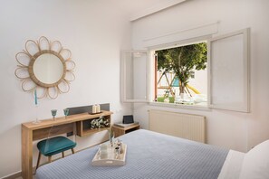 Deluxe Quadruple Room, Pool View | Premium bedding, pillowtop beds, in-room safe, individually decorated - luxsuites (Chania)