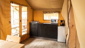 A compact kitchen with a gas stove, microwave, and coffee maker. - Cozy Glamping Tent in Ardennes (Manhay)