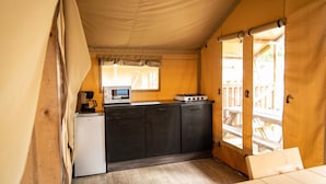 A compact kitchen with a microwave, coffee maker, and gas stove. - Cozy Glamping Tent in Ardennes (Manhay)