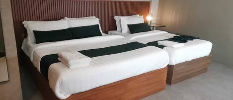 Deluxe Triple Room | Desk, laptop workspace, bed sheets