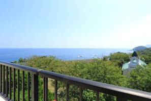 A coastal view with a church and greenery. - Tsushima Grand Hotel (Tsushima)