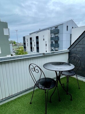 Enjoy a peaceful moment on the rooftop, surrounded by lush greenery and city views.