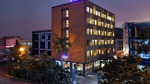 A multi-story building with a prominent 'FOX' sign at the top. - Fox Lite Hotel Cikarang (Cikarang)