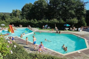 A swimming pool with multiple lanes, surrounded by greenery and trees. - Holiday Home in Grand Est (Signy-l’Abbaye)
